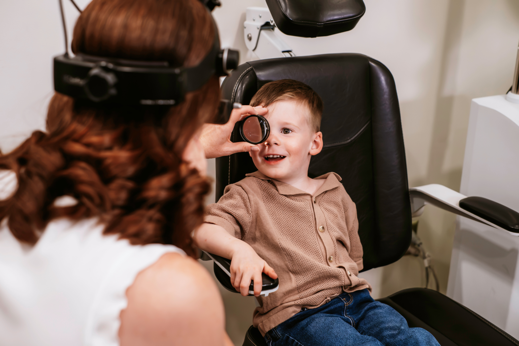 Friendly optometrists helping kids during their eye exams at Aurora Eye Care.