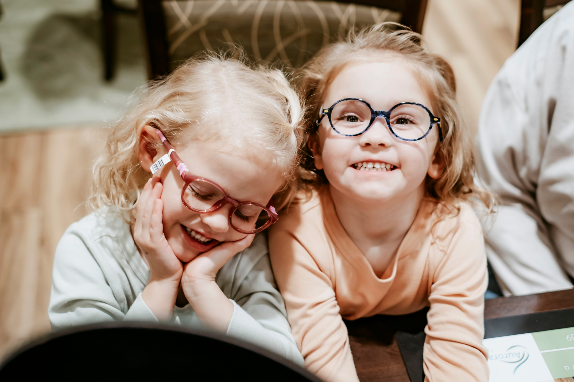 Smiling children wearing glasses from Aurora Eye Care in Grande Prairie.