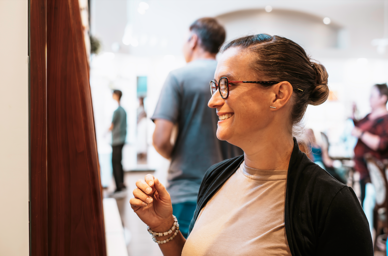 Woman wearing glasses from Aurora Eye Care enjoying clear, comfortable vision.