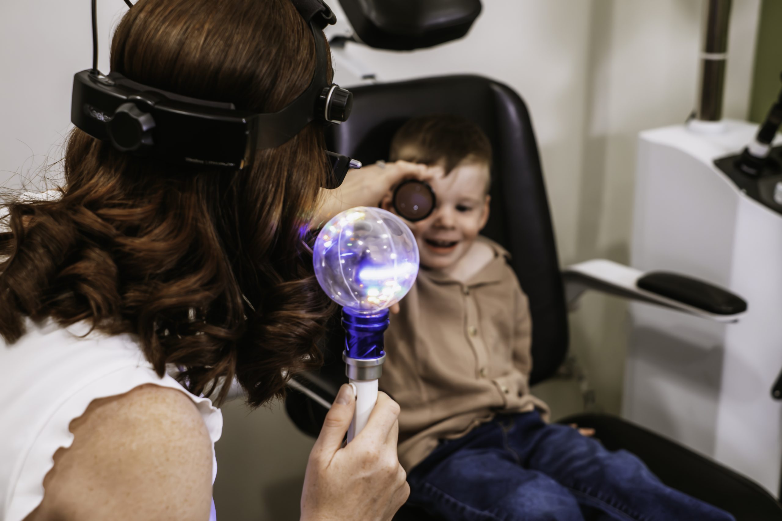 A child having a eye exam in to test eye problems at Aurora Eye Care.