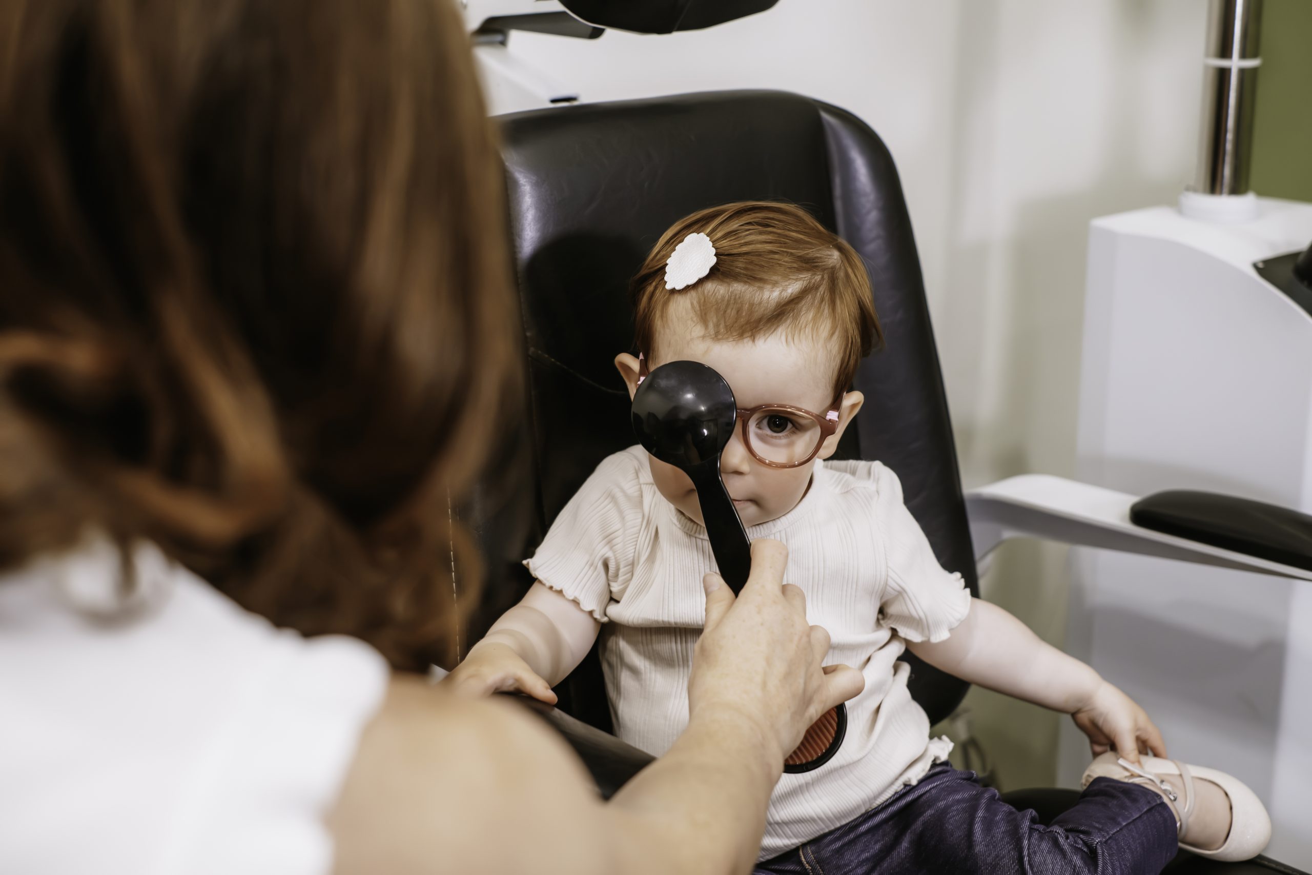 A kid having a eye exam in Grande prairie Alberta at Aurora Eye Care.