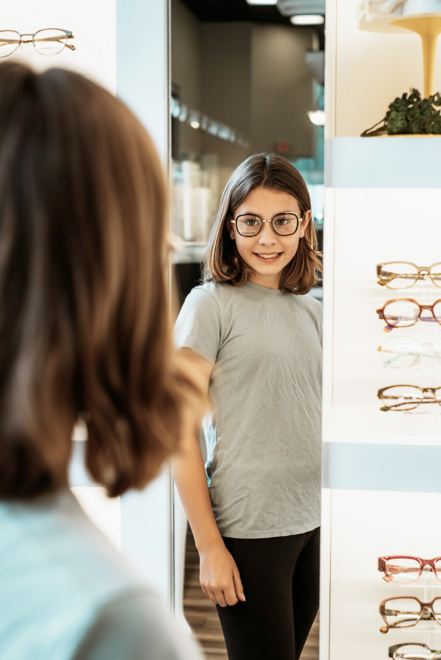 Child wearing new glasses from Aurora Eye Care's Back-to-School Sale